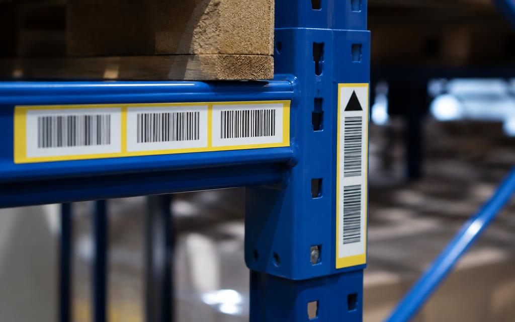 Barcode rack labels and aisle markers on warehouse pallet racking